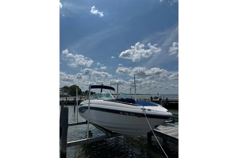 Slide: The Image of 2003 CHAPPARRAL 260 SSI boat docked under a partly cloudy sky. - 2