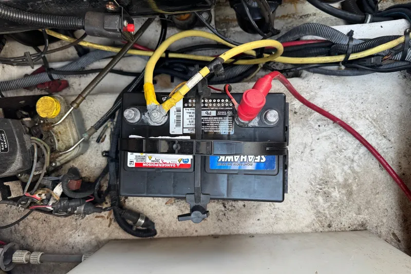 Slide: The Image of Battery compartment of a 2003 CHAPPARRAL 260 SSI boat with connected cables. - 9