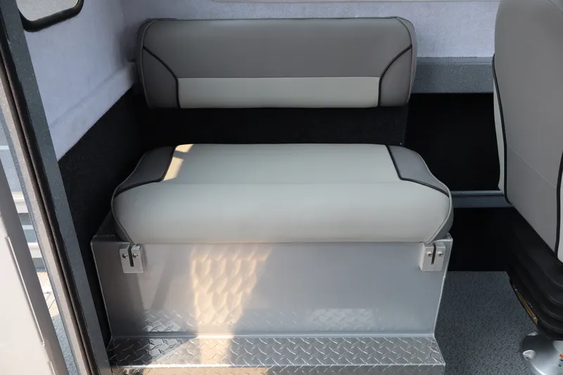 Slide: The Image of Interior seating of 2026 KingFisher 2225 Escape HT boat, featuring cushioned bench and storage. - 20