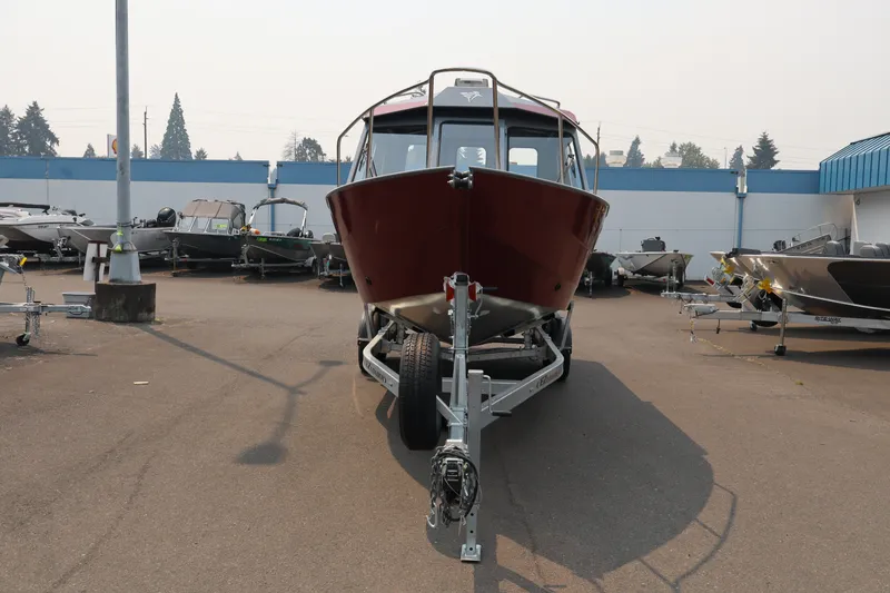 Slide: The Image of 2026 KingFisher 2225 Escape HT boat on trailer in outdoor showroom. - 2