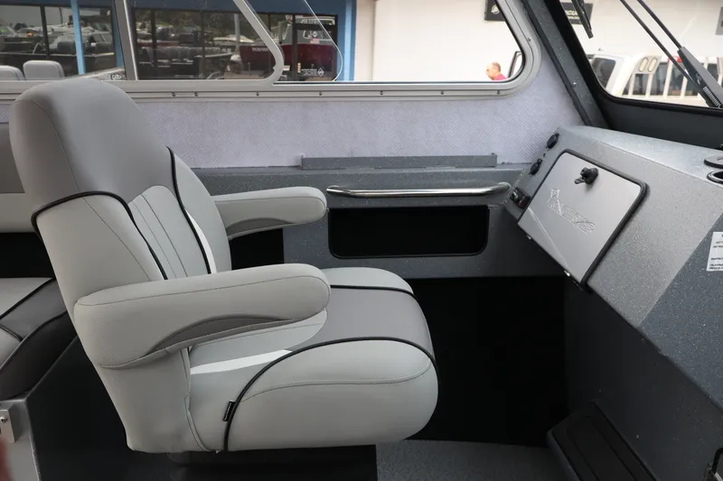 Slide: The Image of Interior of 2026 KingFisher 2225 Escape HT boat, featuring a comfortable captain's chair. - 26