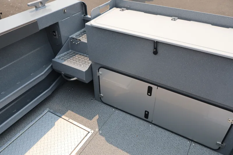 Slide: The Image of Interior view of 2026 KingFisher 2225 Escape HT boat, featuring storage compartments and steps. - 10