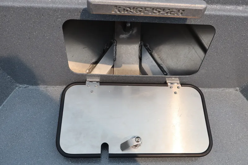Slide: The Image of KingFisher 2225 Escape HT 2026 boat compartment with metal hatch and secure latch. - 31