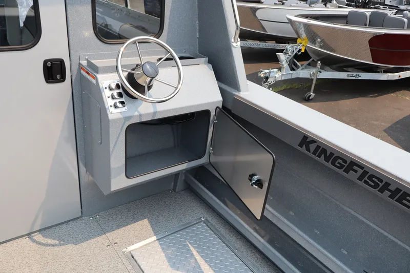 Slide: The Image of Interior of 2026 KingFisher 2225 Escape HT boat, featuring steering wheel and control panel. - 17