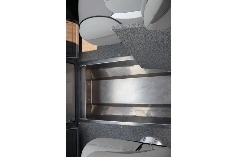 Slide: The Image of 2026 KingFisher 2225 Escape HT interior storage compartment with gray seating and metallic finish. - 35