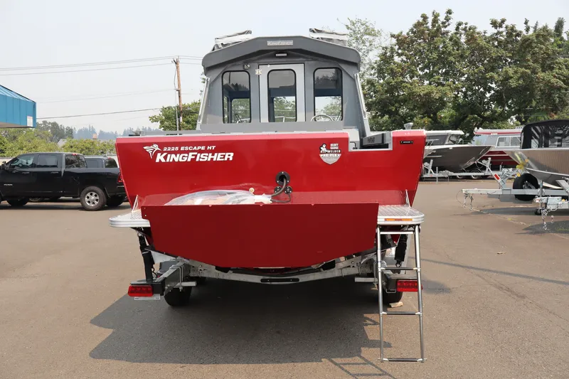 Slide: The Image of Red 2026 KingFisher 2225 Escape HT boat, rear view, parked outdoors. - 6