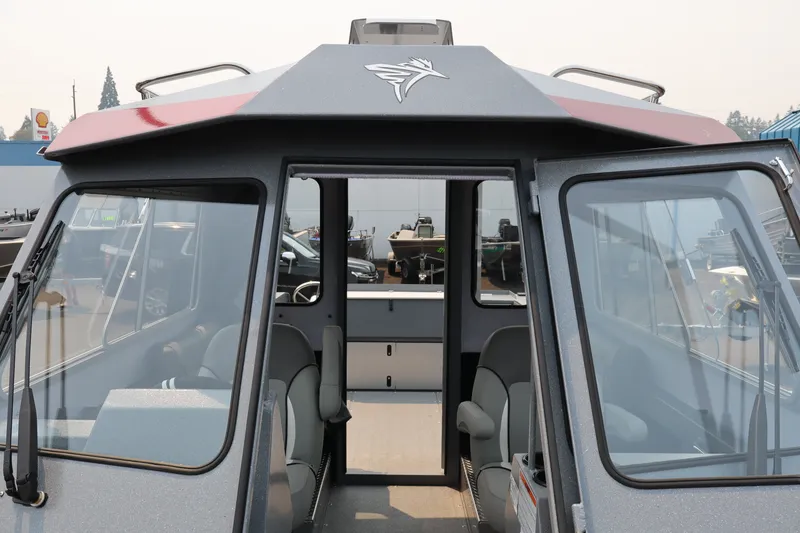 Slide: The Image of 2026 KingFisher 2225 Escape HT boat interior with open cabin doors and seating. - 33