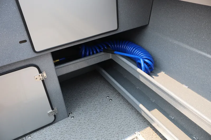 Slide: The Image of Interior storage compartment of 2026 KingFisher 2225 Escape HT boat with coiled blue hose. - 12