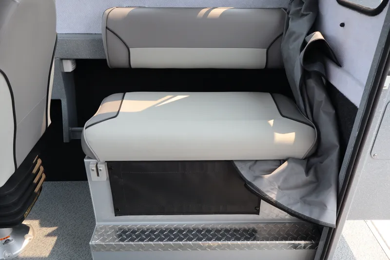 Slide: The Image of Interior seating of 2026 KingFisher 2225 Escape HT boat, featuring cushioned bench and storage. - 21