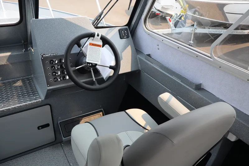Slide: The Image of Interior of 2026 KingFisher 2225 Escape HT boat, featuring steering wheel and control panel. - 22