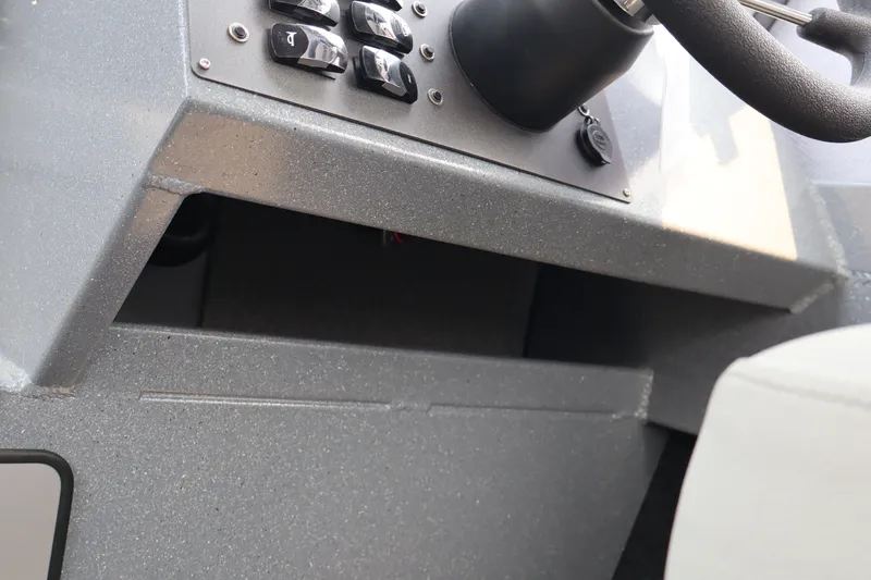 Slide: The Image of Control panel of 2026 KingFisher 2225 Escape HT boat, featuring switches and steering wheel. - 37
