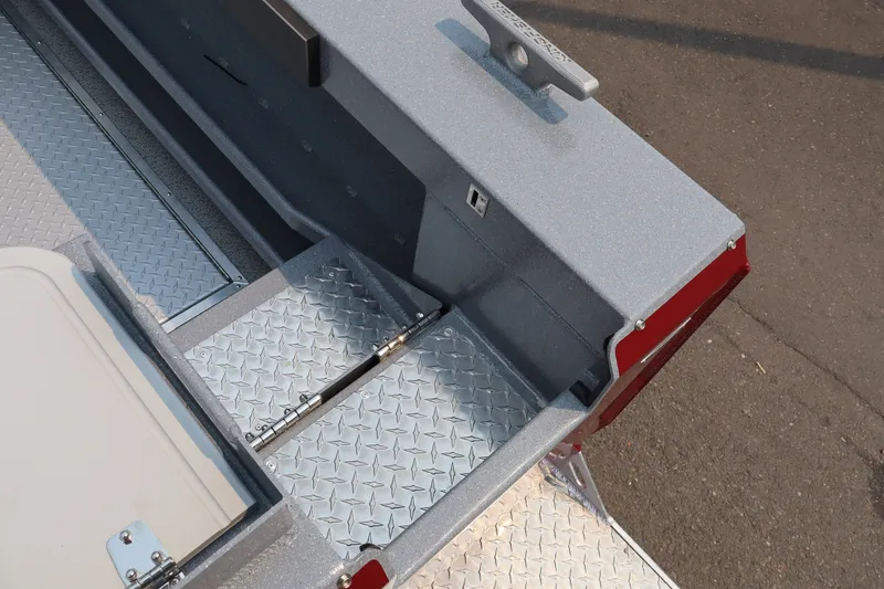 Slide: The Image of 2026 KingFisher 2225 Escape HT boat with diamond plate flooring and storage compartment. - 7