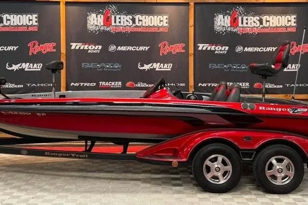 The Image of 2008 Ranger Z520 boat in showroom, red and black design, Anglers Choice backdrop. - 1