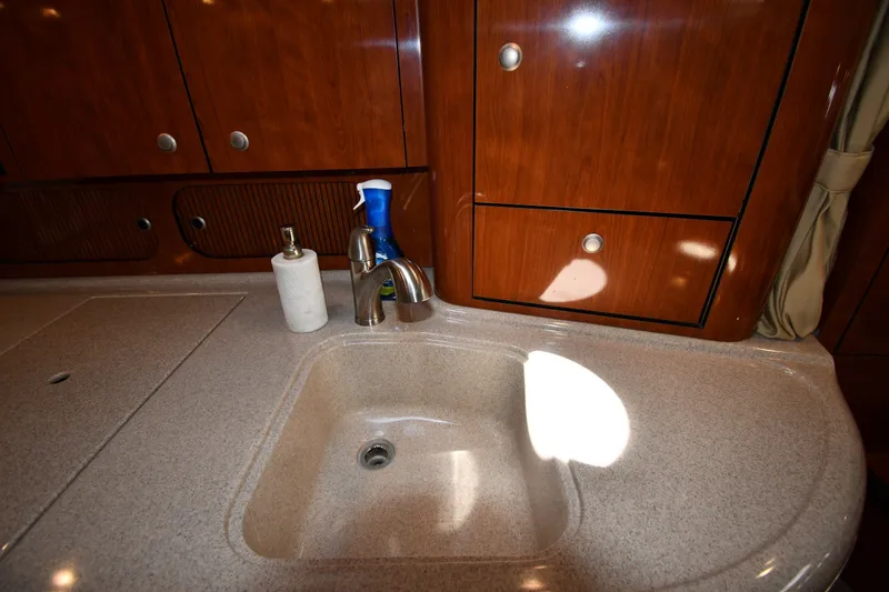 Slide: The Image of Luxurious 2007 Sea Ray 340 Sundancer yacht interior with sink and wooden cabinetry. - 36