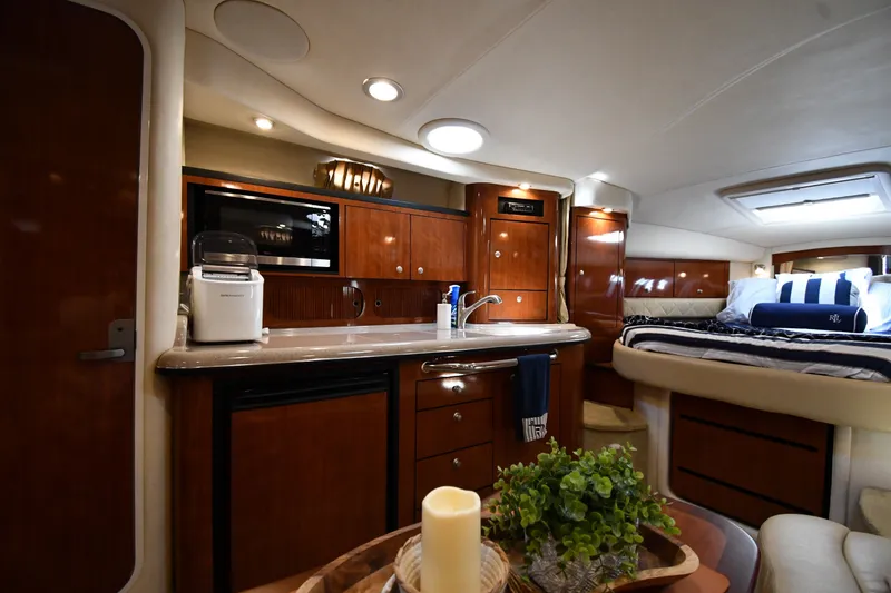 Slide: The Image of Luxurious interior of 2007 Sea Ray 340 Sundancer yacht with kitchenette and cozy sleeping area. - 33