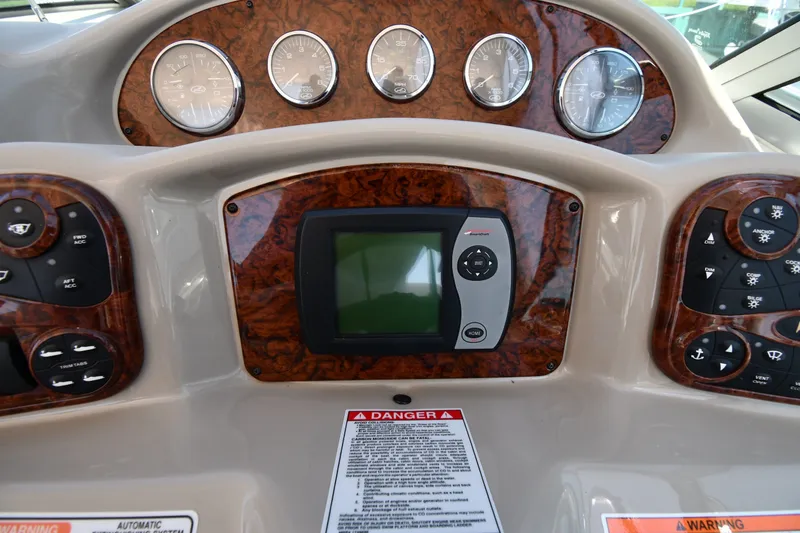 Slide: The Image of Dashboard of a 2007 Sea Ray 340 Sundancer boat with gauges and controls. - 14