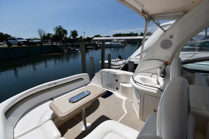 Slide: The Image of 2007 Sea Ray 340 Sundancer yacht interior with seating and sink, docked at marina. - 19