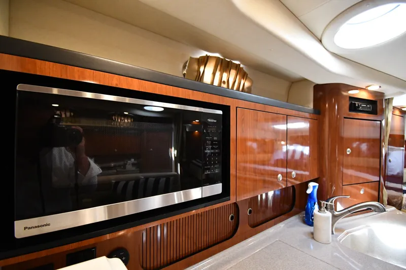Slide: The Image of Luxurious 2007 Sea Ray 340 Sundancer yacht kitchen with microwave and sleek cabinetry. - 38
