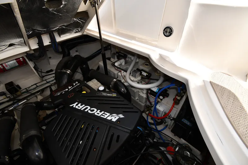 Slide: The Image of Engine compartment of 2007 Sea Ray 340 Sundancer with Mercury engine components. - 49