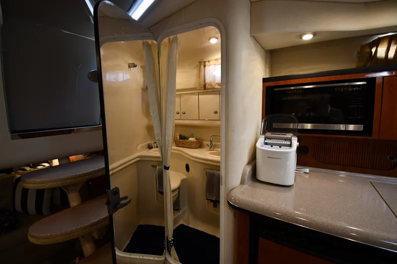 Slide: The Image of Interior of 2007 Sea Ray 340 Sundancer yacht featuring kitchenette and compact bathroom. - 40