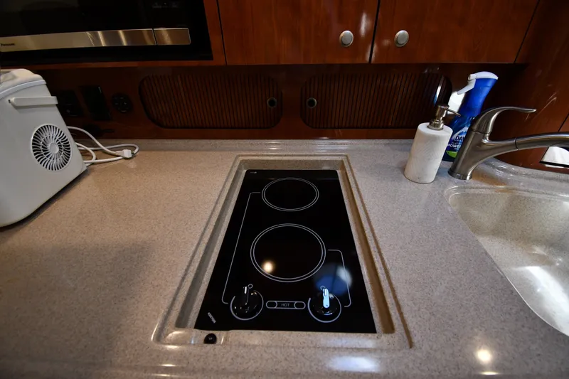 Slide: The Image of 2007 Sea Ray 340 Sundancer kitchen with electric stove and sink. - 37