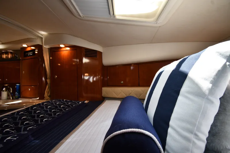 Slide: The Image of Luxurious cabin interior of 2007 Sea Ray 340 Sundancer with striped pillows and wood finish. - 30