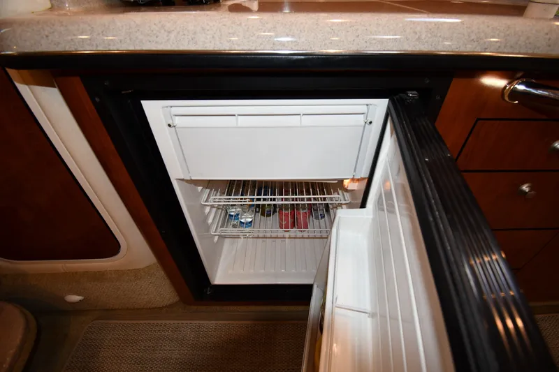 Slide: The Image of Open refrigerator inside 2007 Sea Ray 340 Sundancer yacht, showing stocked shelves. - 39