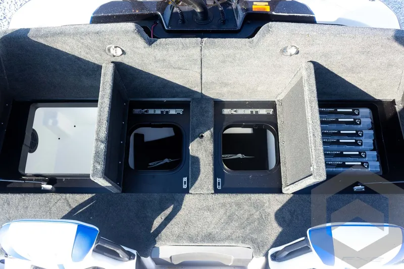 Slide: The Image of 2027 Skeeter FXE21 Limited boat storage compartments with organized fishing gear. - 25