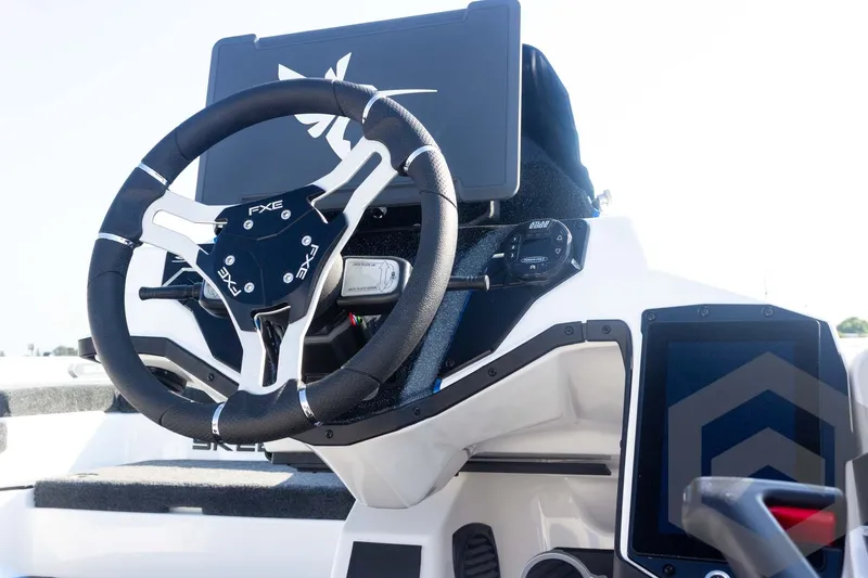 Slide: The Image of Steering wheel and dashboard of 2027 Skeeter FXE21 Limited boat, featuring modern controls. - 16