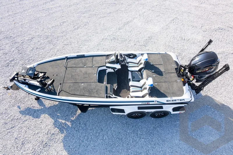 Slide: The Image of 2027 Skeeter FXE21 Limited fishing boat on gravel, featuring dual seats and powerful outboard motor. - 32
