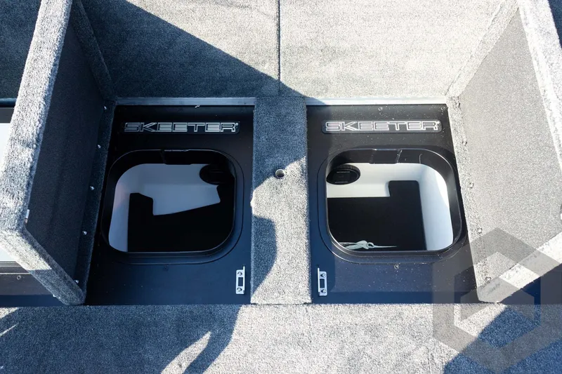 Slide: The Image of 2027 Skeeter FXE21 Limited boat storage compartments with open lids, showcasing interior space. - 26