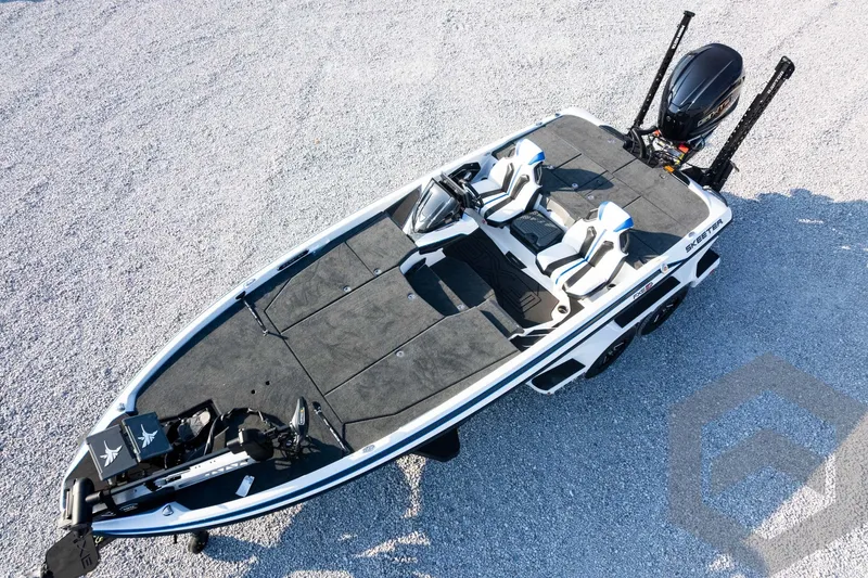 Slide: The Image of 2027 Skeeter FXE21 Limited fishing boat on gravel, featuring dual seats and advanced equipment. - 31