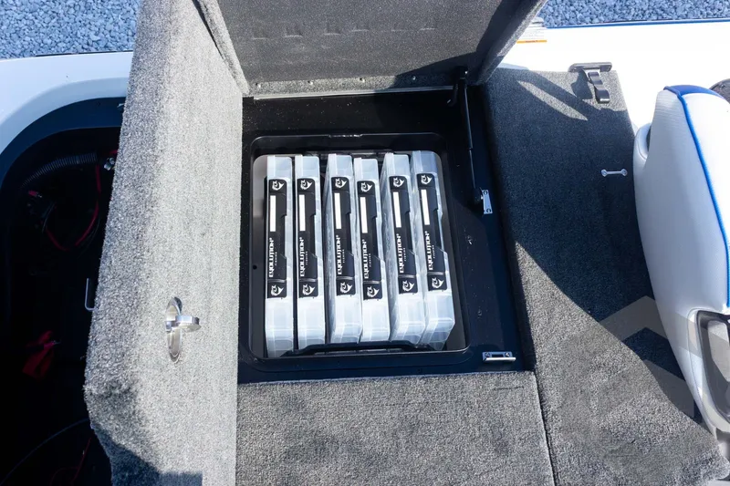 Slide: The Image of Storage compartment in 2027 Skeeter FXE21 Limited boat with organized tackle boxes. - 27