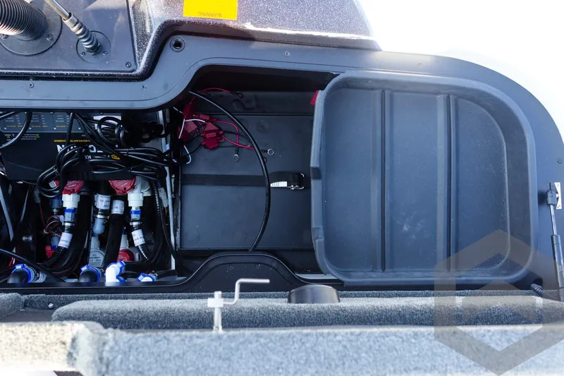 Slide: The Image of 2027 Skeeter FXE21 Limited boat compartment with wiring and storage space. - 29