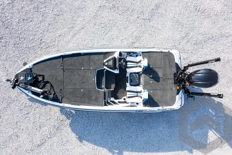 Slide: The Image of Aerial view of 2027 Skeeter FXE21 Limited fishing boat on gravel surface. - 40