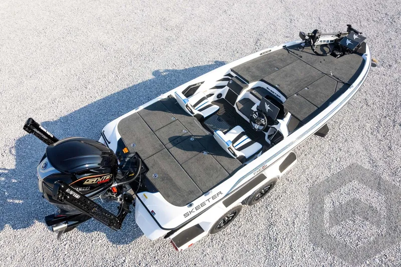 Slide: The Image of 2027 Skeeter FXE21 Limited fishing boat on gravel, featuring sleek design and powerful engine. - 35