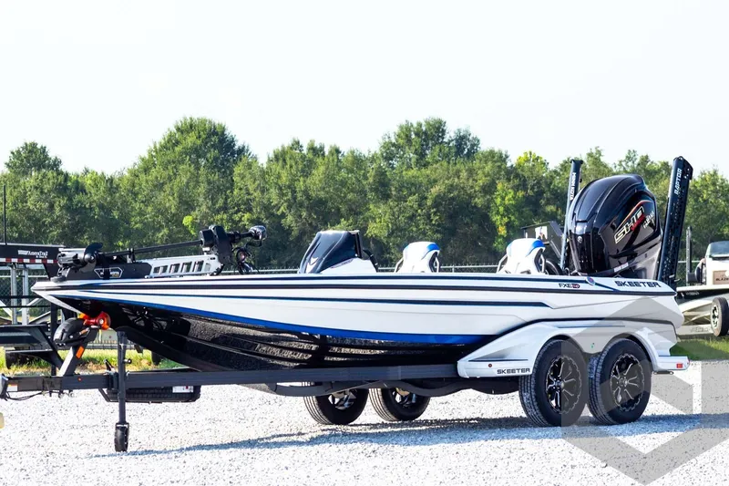 The Image of 2027 Skeeter FXE21 Limited boat on trailer, sleek design, parked outdoors. - 1