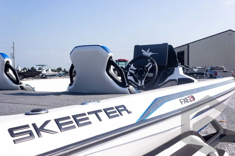 Slide: The Image of 2027 Skeeter FXE21 Limited boat with sleek design and modern steering console. - 15