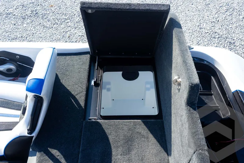 Slide: The Image of 2027 Skeeter FXE21 Limited boat storage compartment with open lid, showcasing interior details. - 28