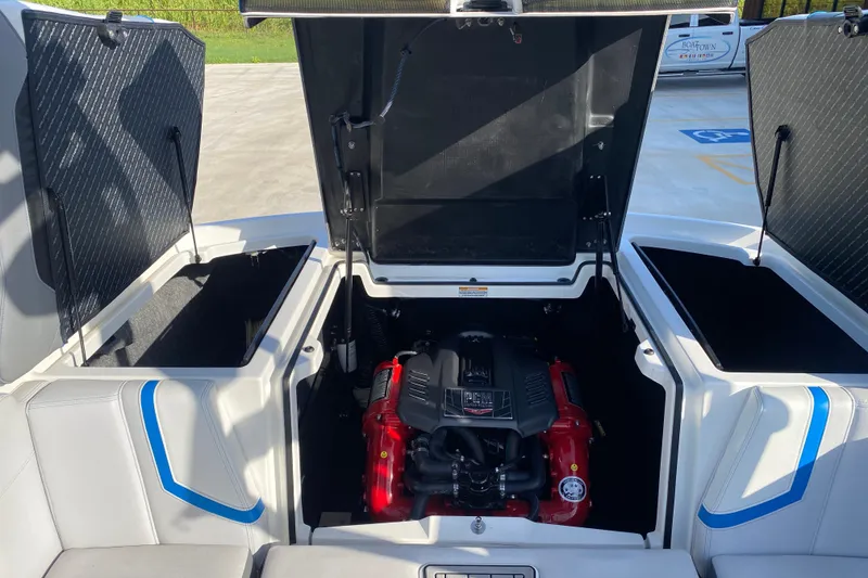 Slide: The Image of 2018 Nautique Super Air Nautique G21 engine compartment with open hatches and visible PCM engine. - 35