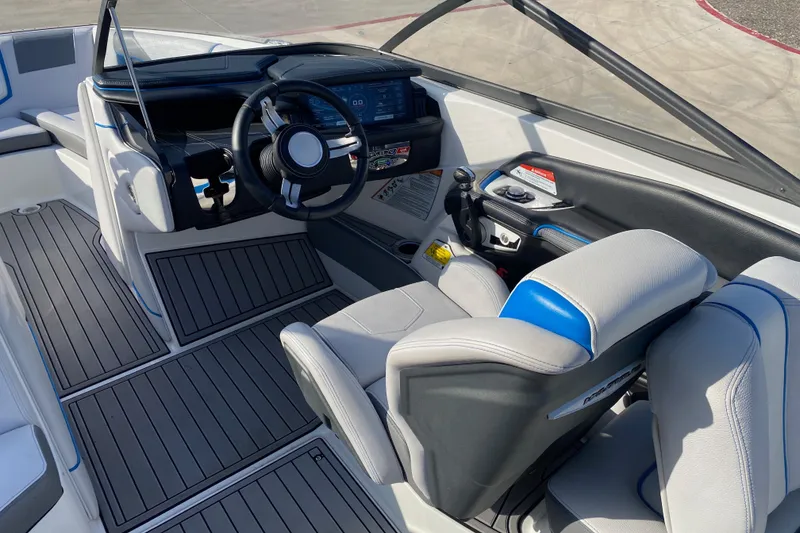 Slide: The Image of Interior of 2018 Nautique Super Air Nautique G21 boat, featuring sleek dashboard and seating. - 28
