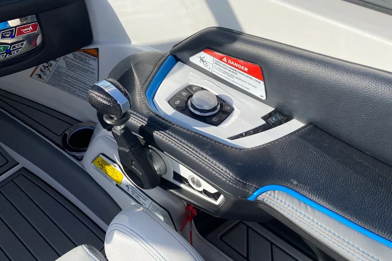 Slide: The Image of 2018 Nautique Super Air Nautique G21 boat control panel with throttle and warning labels. - 38