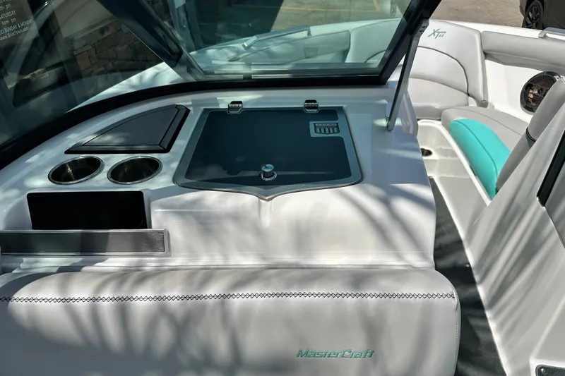 Slide: The Image of Interior of a 2018 MasterCraft XT23 boat, featuring seating and cup holders. - 29