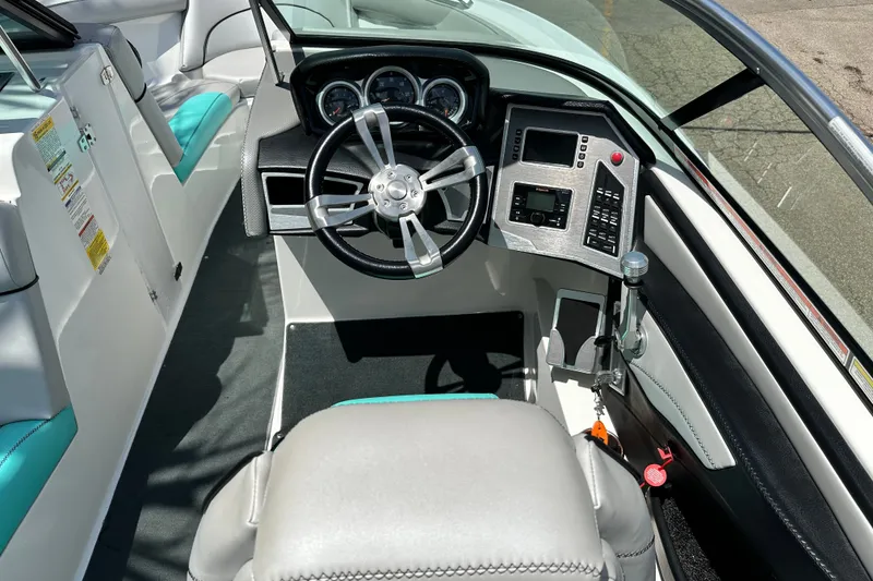 Slide: The Image of 2018 MasterCraft XT23 boat cockpit with modern steering and control panel. - 22