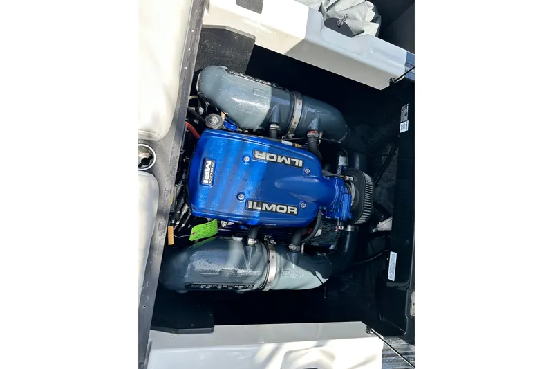 Slide: The Image of 2018 MasterCraft XT23 Ilmor engine, blue cover, detailed view. - 23