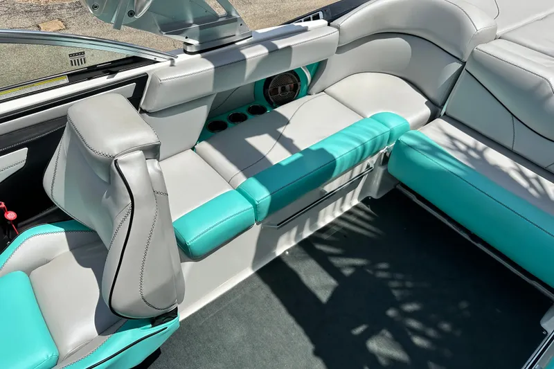 Slide: The Image of Interior of a 2018 MasterCraft XT23 boat with teal and gray seating. - 26