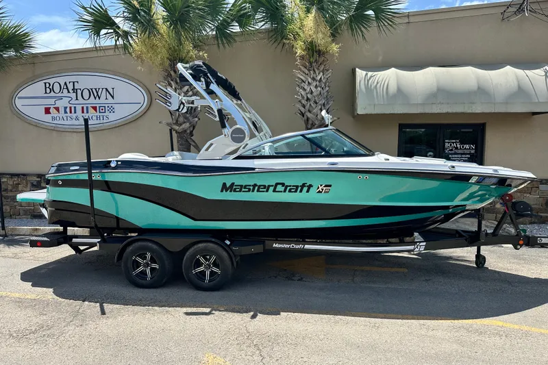 The Image of 2018 MasterCraft XT23 boat on trailer at Boat Town dealership. - 9