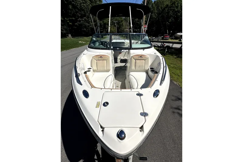 Slide: The Image of 2007 Monterey 234FSX boat with open bow seating, parked on a sunny day. - 5
