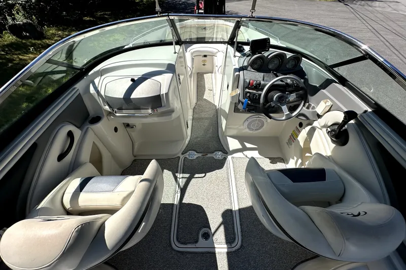 Slide: The Image of Interior view of a 2007 Monterey 234FSX boat, featuring steering wheel and seating. - 7