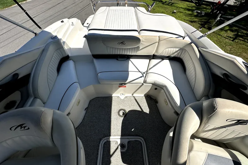 Slide: The Image of 2007 Monterey 234FSX boat interior with plush seating and carpeted flooring. - 8